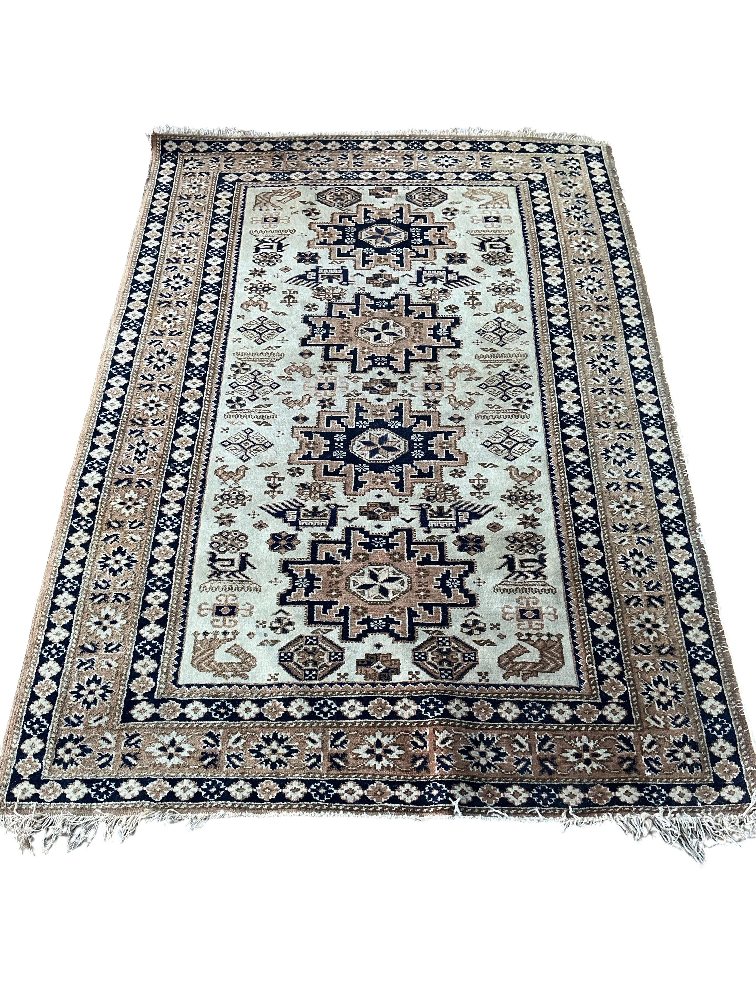 A Caucasian style ivory ground rug, 162 x 114cm